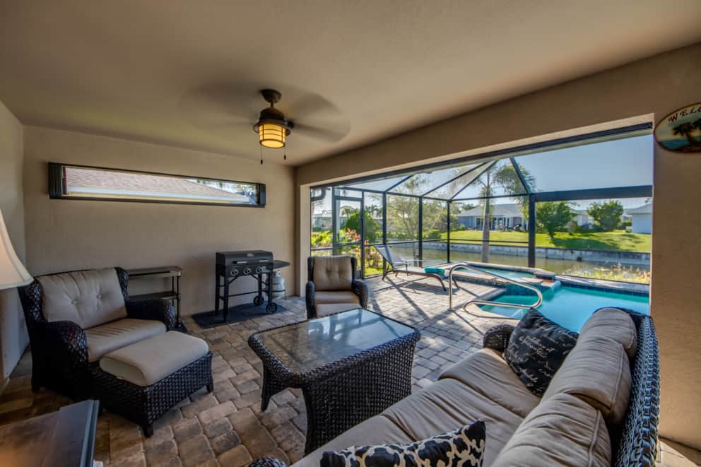 Covered outdoor living area with pool view